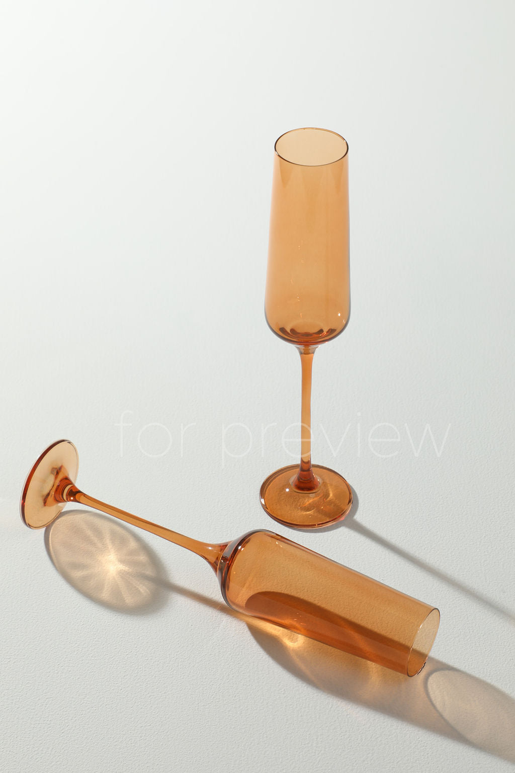 Colourful flute in pastel orange color for champagne