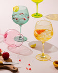 Pastel goblets with gin cocktails, pomegranate and citrus