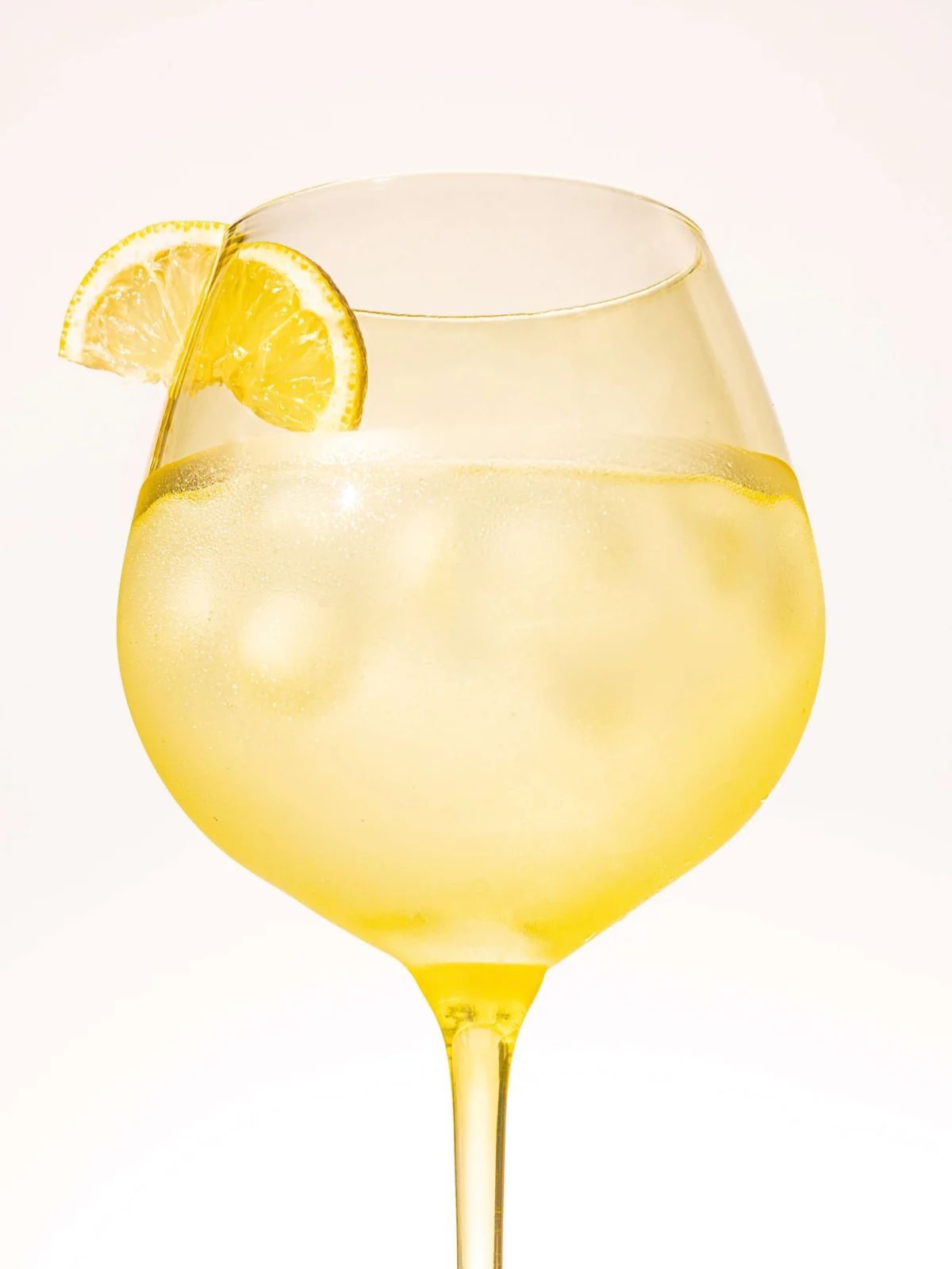 Summer Yellow goblet with ice and a lemon slice